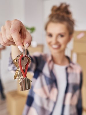 Woman's hand showing keys from new apartment